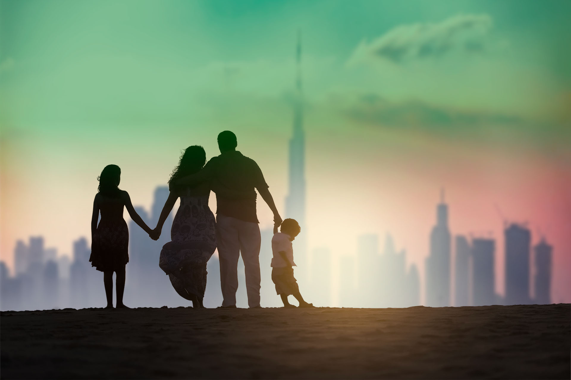Family on the beach in front of the Dubai skyline